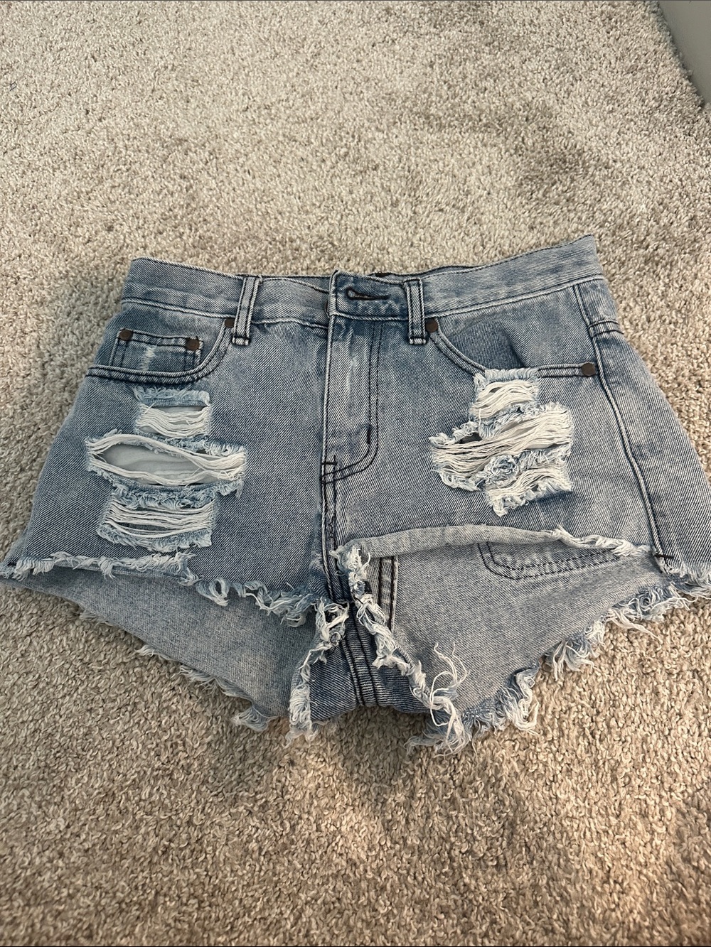 High-Rise Distressed Denim Shorts in Light Blue size 25